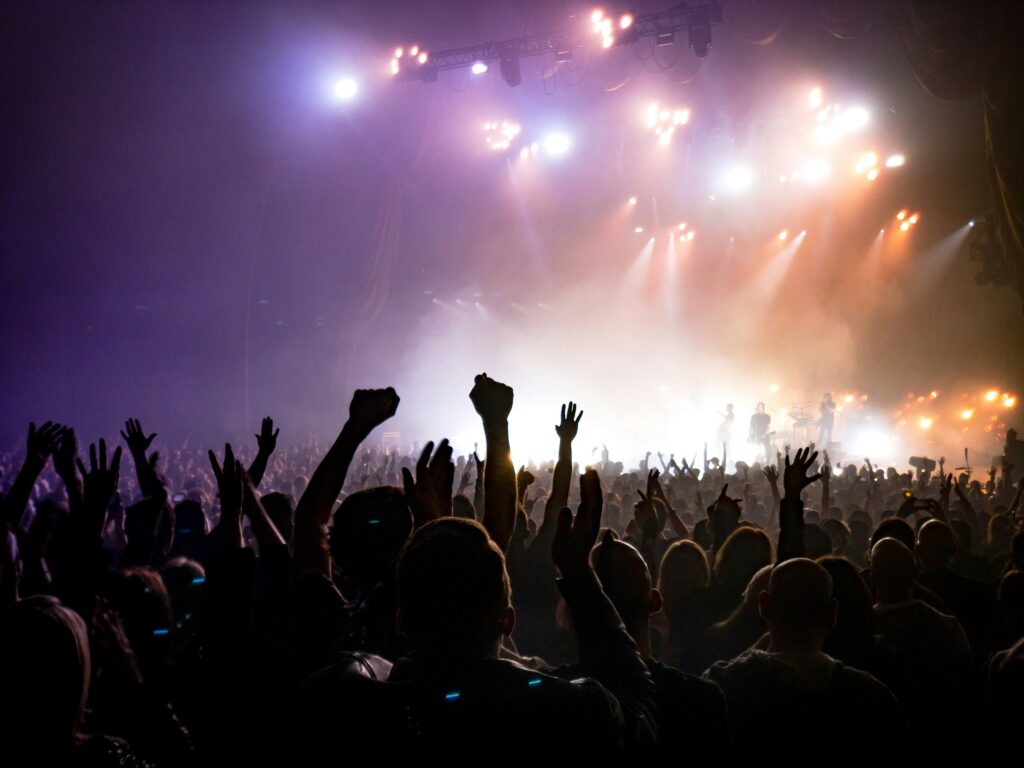 Local concert transportation service in Chicago, Concert crowd with stage lights at a Chicago live music venue, from Stop & Go Limo Airport Shuttle Service.