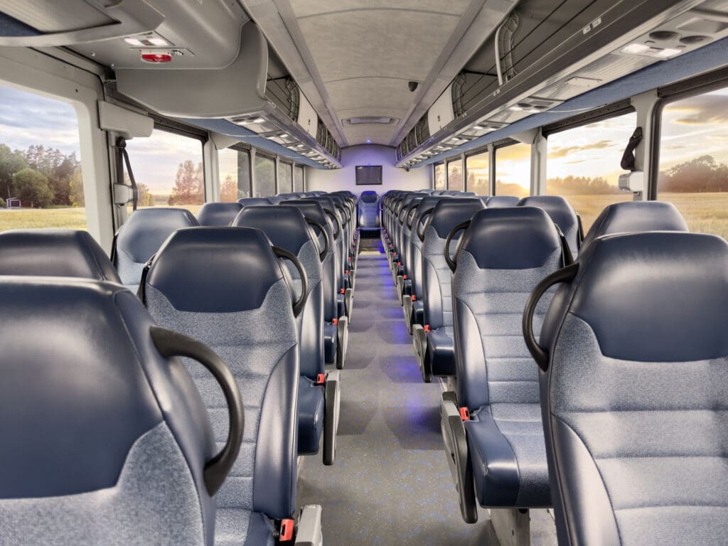 Local group transportation service in Chicagoland, Coach bus interior with rows of passenger seats and overhead storage, from Stop & Go Limo Airport Shuttle Service.
