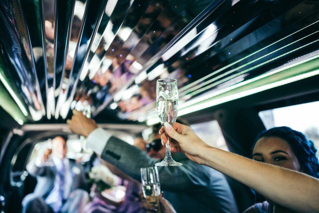 Local airport shuttle service in Chicagoland, Guests celebrating inside a Airport Shuttle Service limousine, from Stop & Go Limo Airport Shuttle Service.