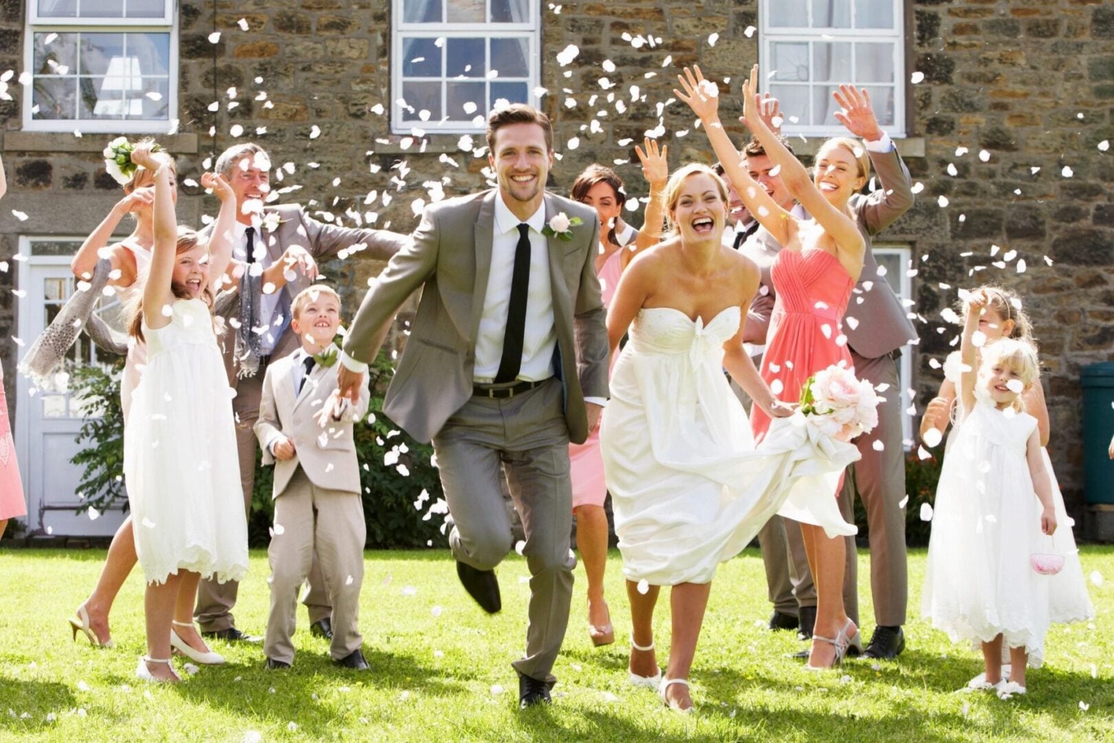 Local wedding transportation service in Chicagoland, Joyful wedding party celebrating outside the venue, from Stop & Go Limo Airport Shuttle Service.