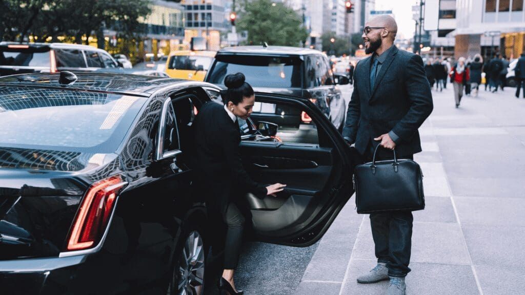 Local airport shuttle service in Chicagoland, Driver greeting a client at the airport terminal, from Stop & Go Limo Airport Shuttle Service.