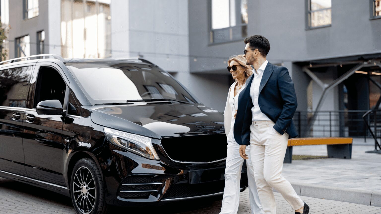Local chauffeured transportation service in Chicagoland, Chauffeur walking a client to a black luxury SUV, from Stop & Go Limo Airport Shuttle Service.